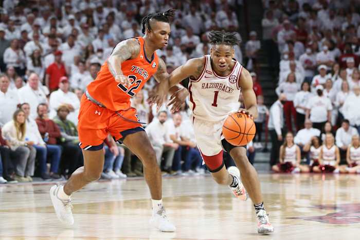 Feb 8, 2022; Fayetteville, Arkansas, USA; Arkansas Razorbacks guard JD Notae (1) drives against Auburn Tigers guard Allen Flanigan (22) at Bud Walton Arena. Arkansas won 80-76. Mandatory Credit: Nelson Chenault-USA TODAY Sports